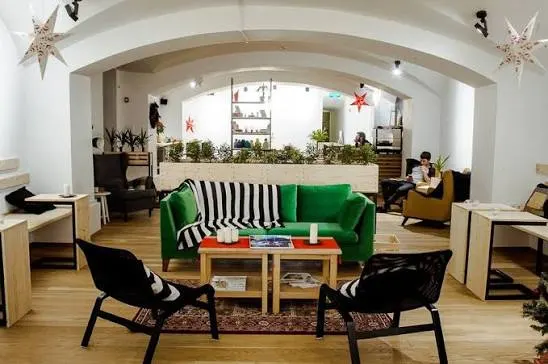 The coworking space — a green sofa and working tables